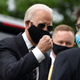 A photo of Joe Biden either in the beginning phases of dapping someone up or about to punch something. Odds are 50-50.